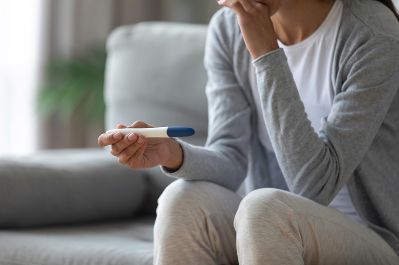 woman looking at pregnancy test